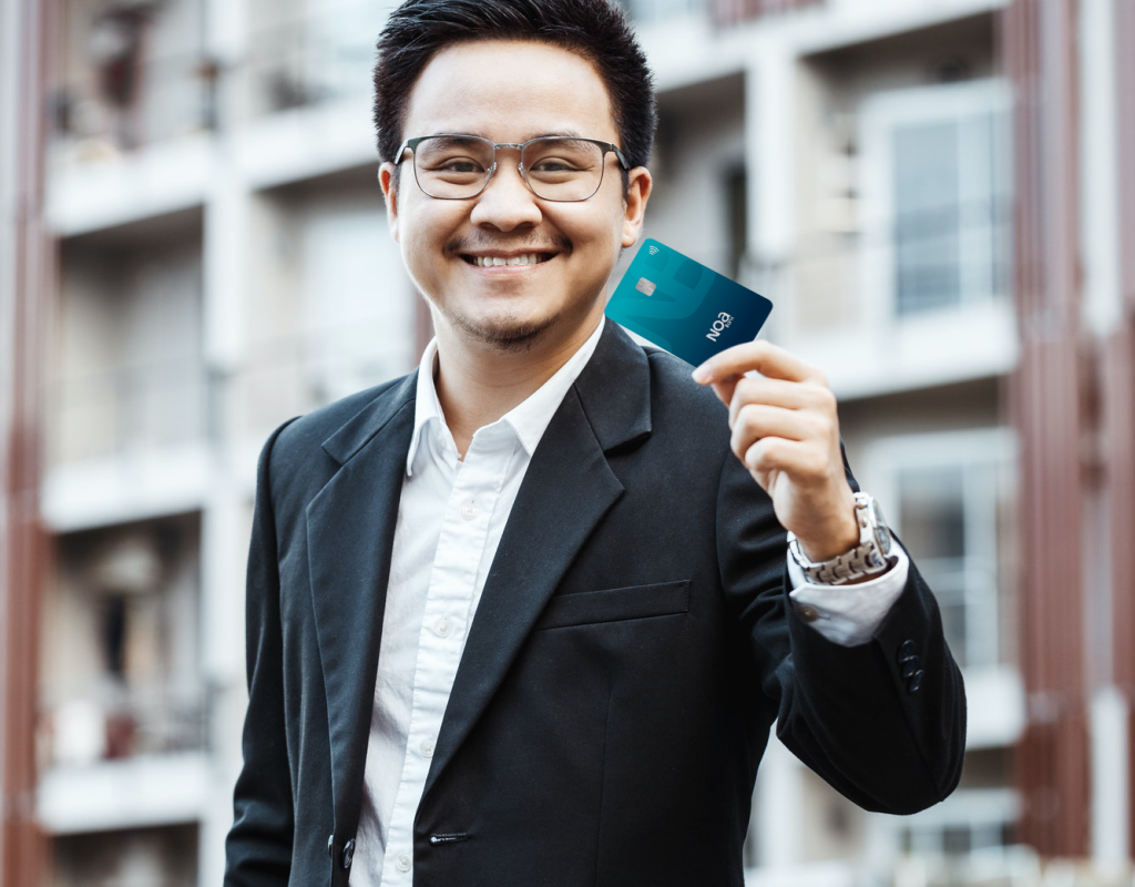 young-handsome-man-enjoy-shopping-online-on-mobile-phone-with-credit-card-noa-bank